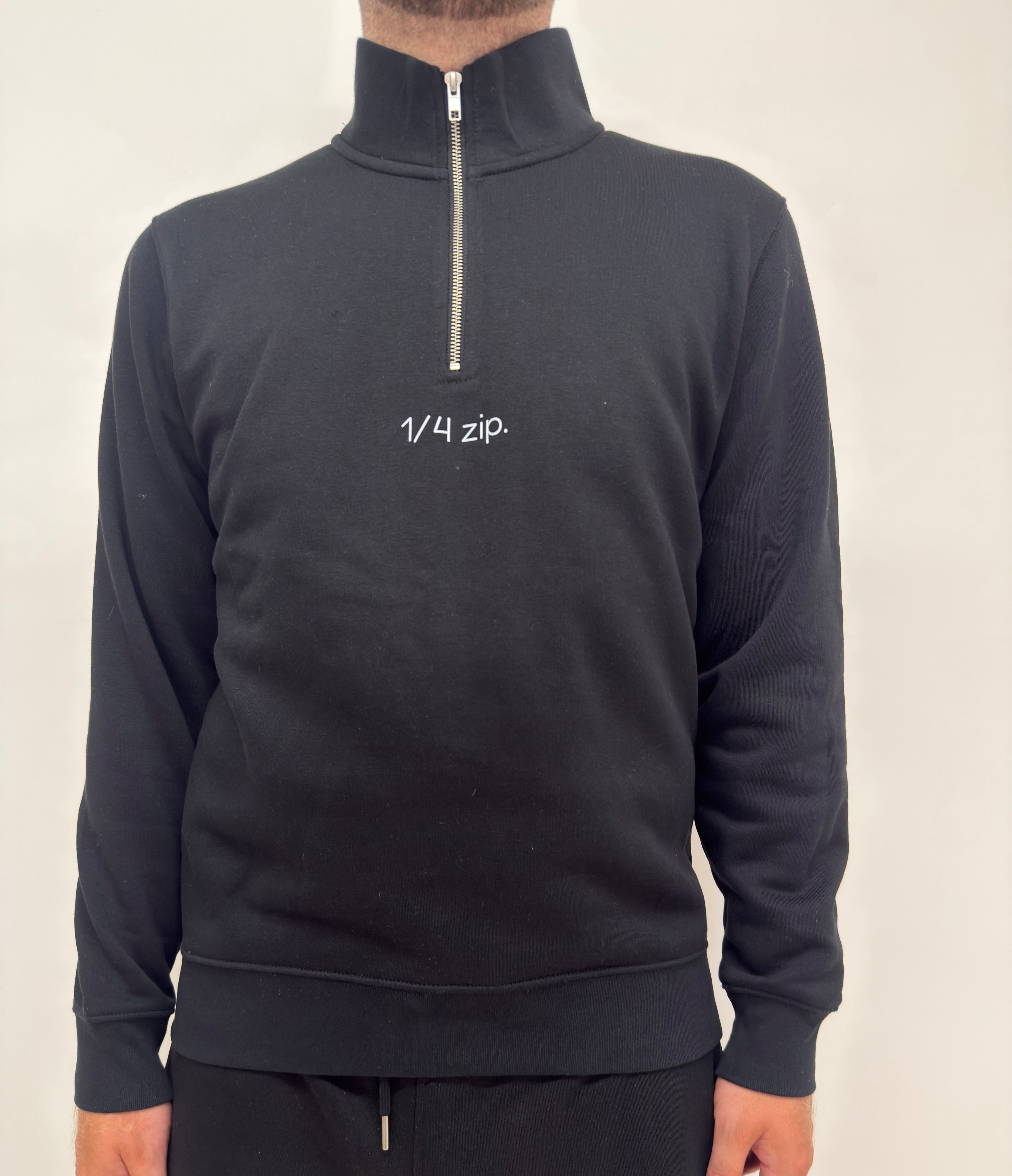 simple. light 1/4 zip. black.