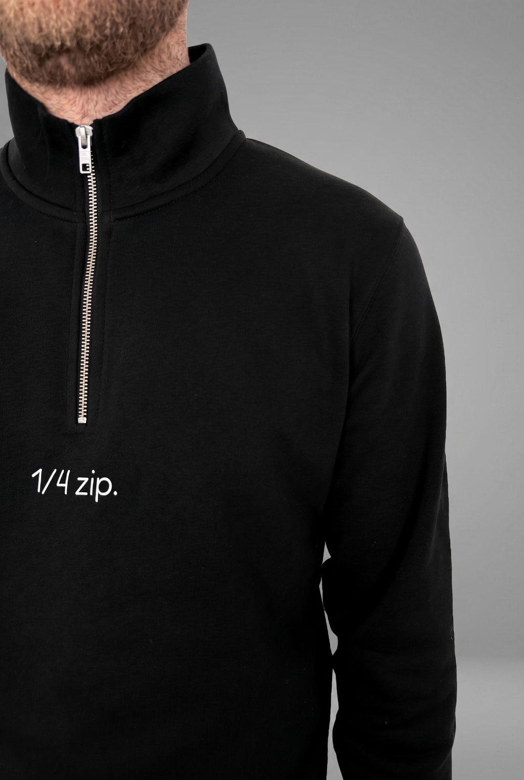 simple. light 1/4 zip. black.