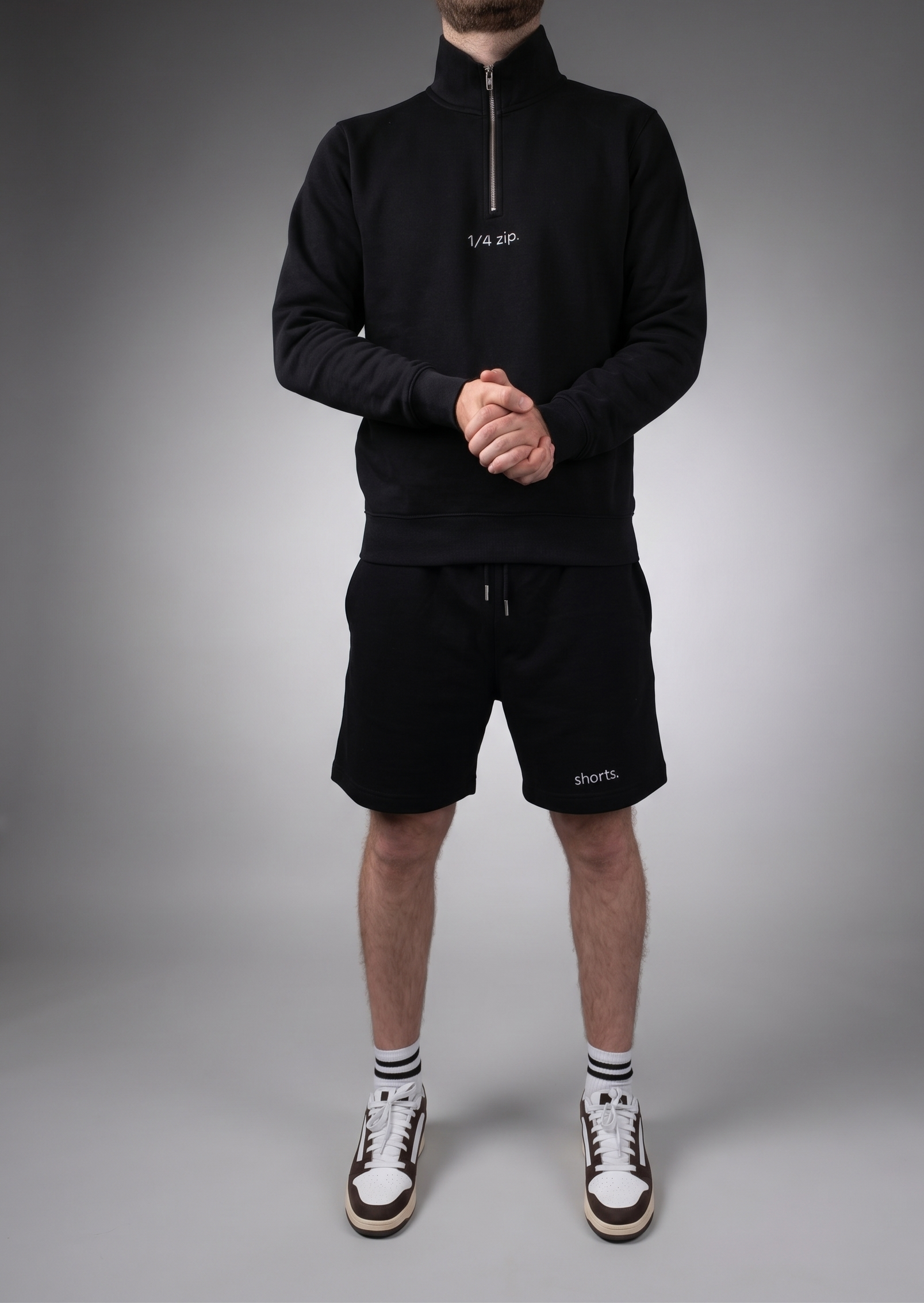 simple. light 1/4 zip. black.